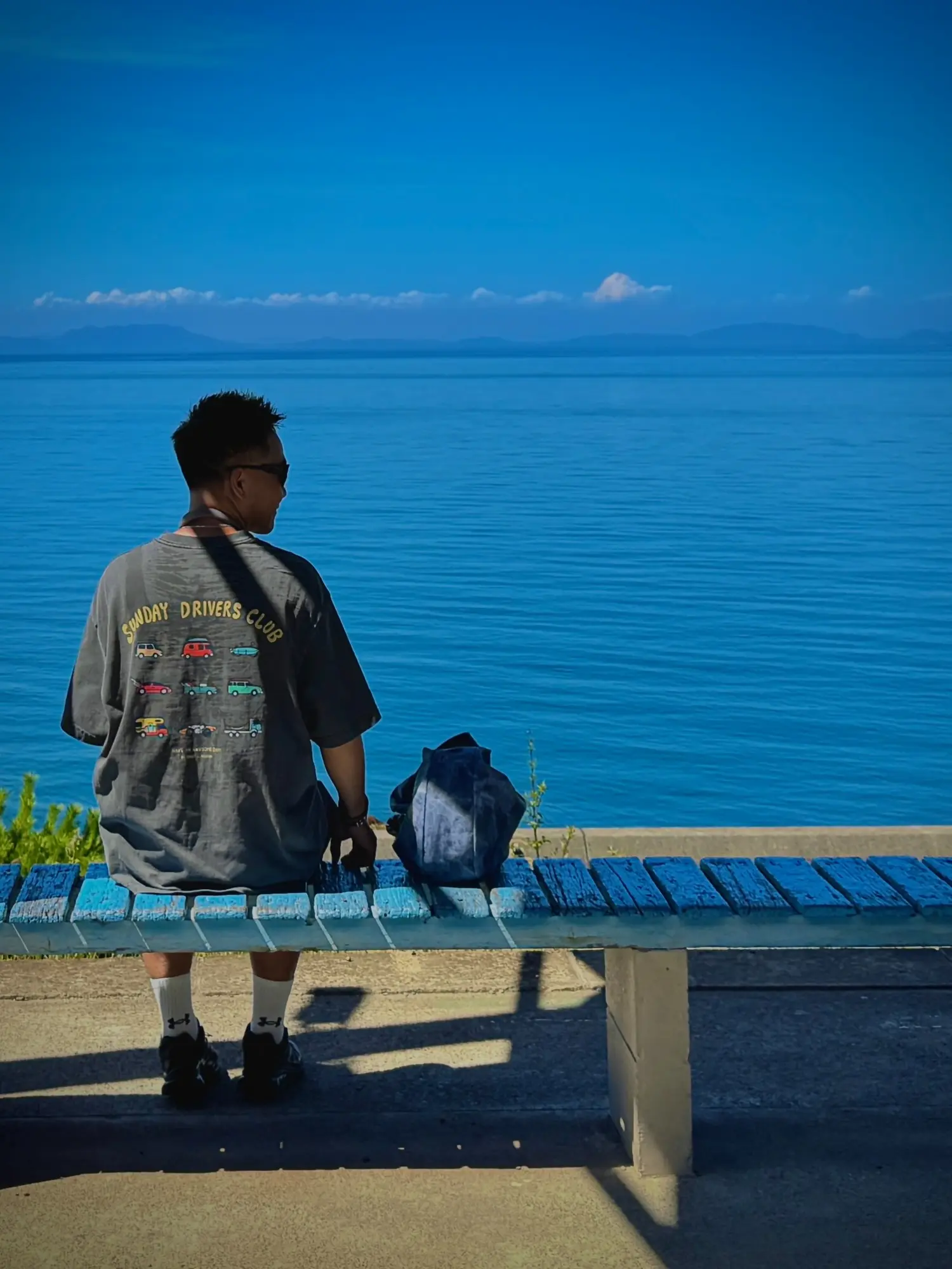 Bobby sitting beside a deep blue sea
